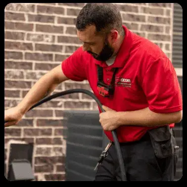 inspecting a duct with a hose in hand
