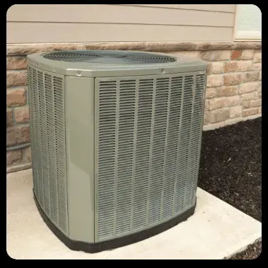 A gray outdoor HVAC unit sits on a concrete pad