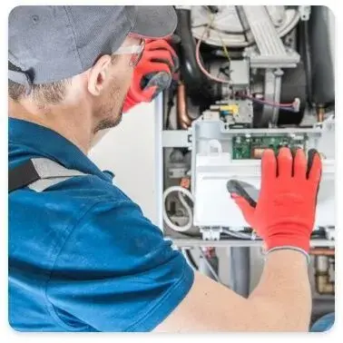 technician inspects the control panel of a furnace